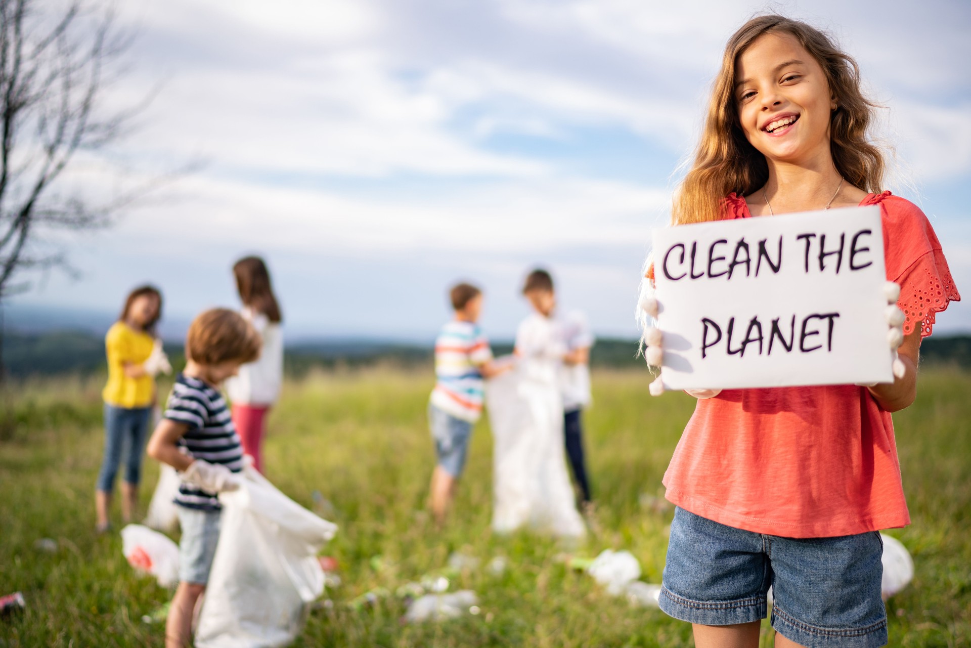 Girl with messages "Clean the Planet"